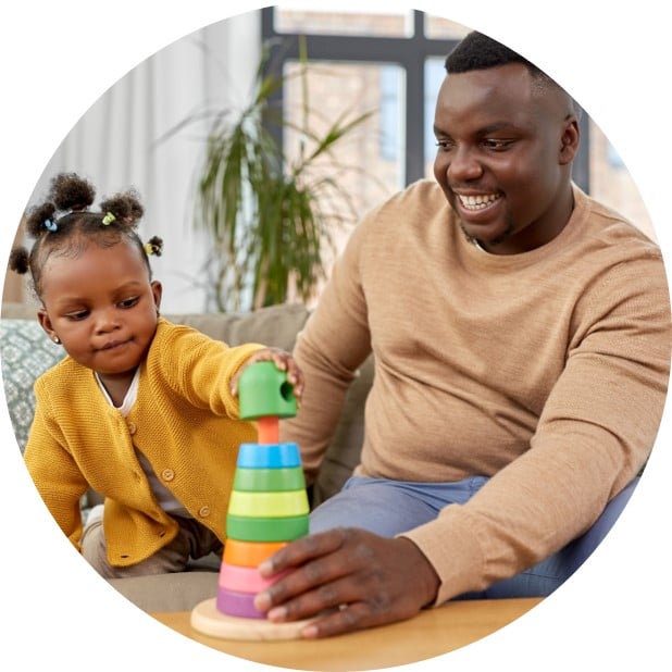 Dad playing with child to work on visual motor skills